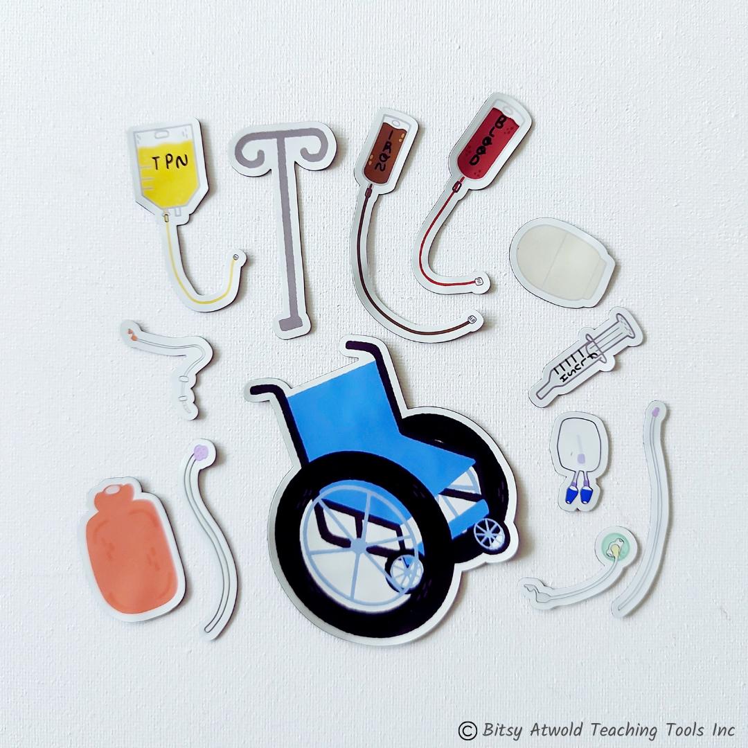 All the cute medical pieces for the Bitsy Buddies Feeding Tube set are shown on a white canvas background. These include a hot water bottle, NG tube with tape, iron infusion, blood transfusion, IV pole, PICC line, syringe flush, ostomy pouch, TPN bag, mic-key with extension, G tube extension, and a blue wheelchair.