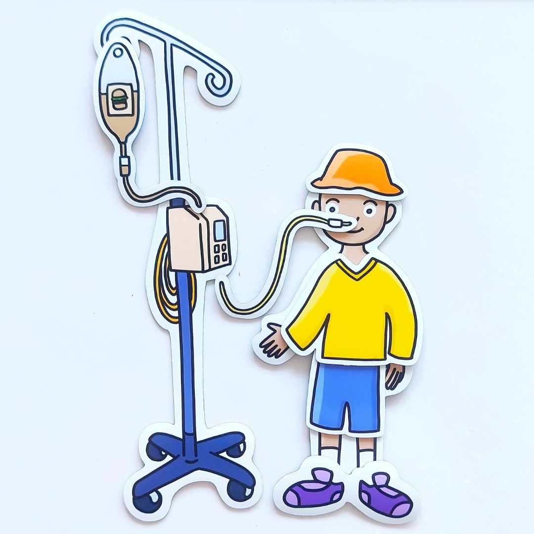 A child is receiving nourishment through an NG tube taped to their cheek. They’re wear a happy yellow sweater, blue shorts, purple sneakers, and an orange hat.
